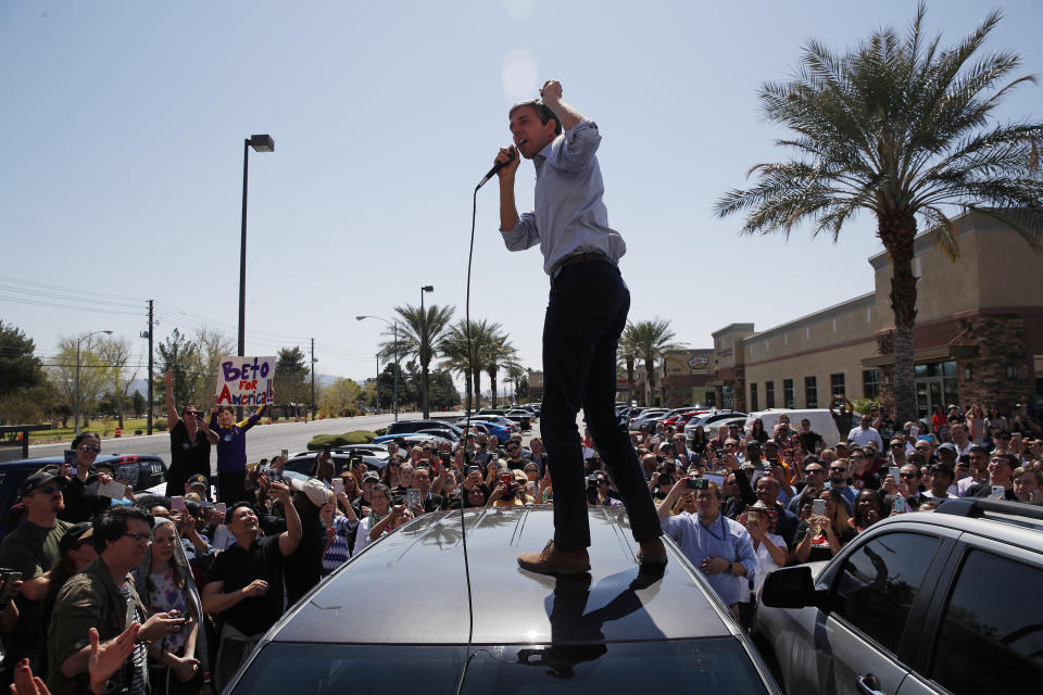 Democratic presidential candidate and former Texas congressman Beto O'Rourke speaks from the roof of his car to an overflow crowd at a campaign stop at a coffee shop Sunday, March 24, 2019, in Las Vegas. (AP Photo/John Locher)