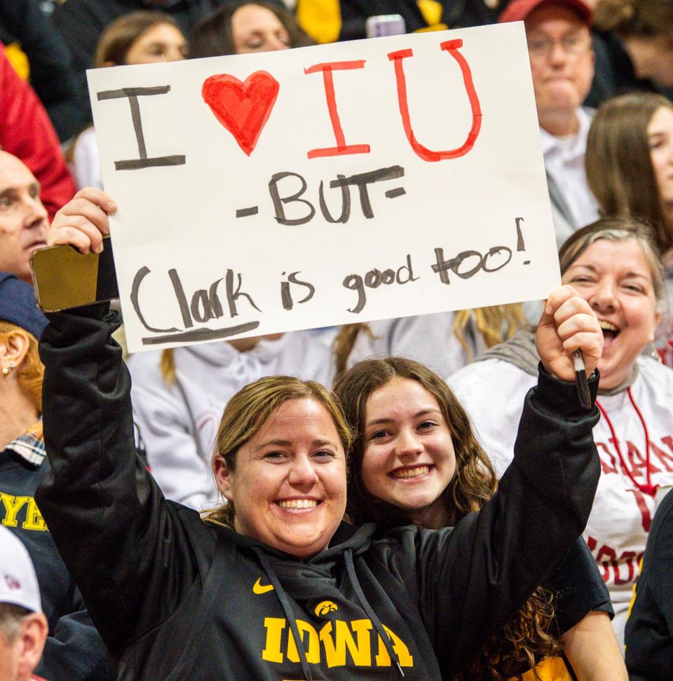 Fans hold up signs and smile before the Indiana versus Iowa women's basketball game at Simon Skjodt Assembly Hall on Thursday, Feb. 22, 2024.