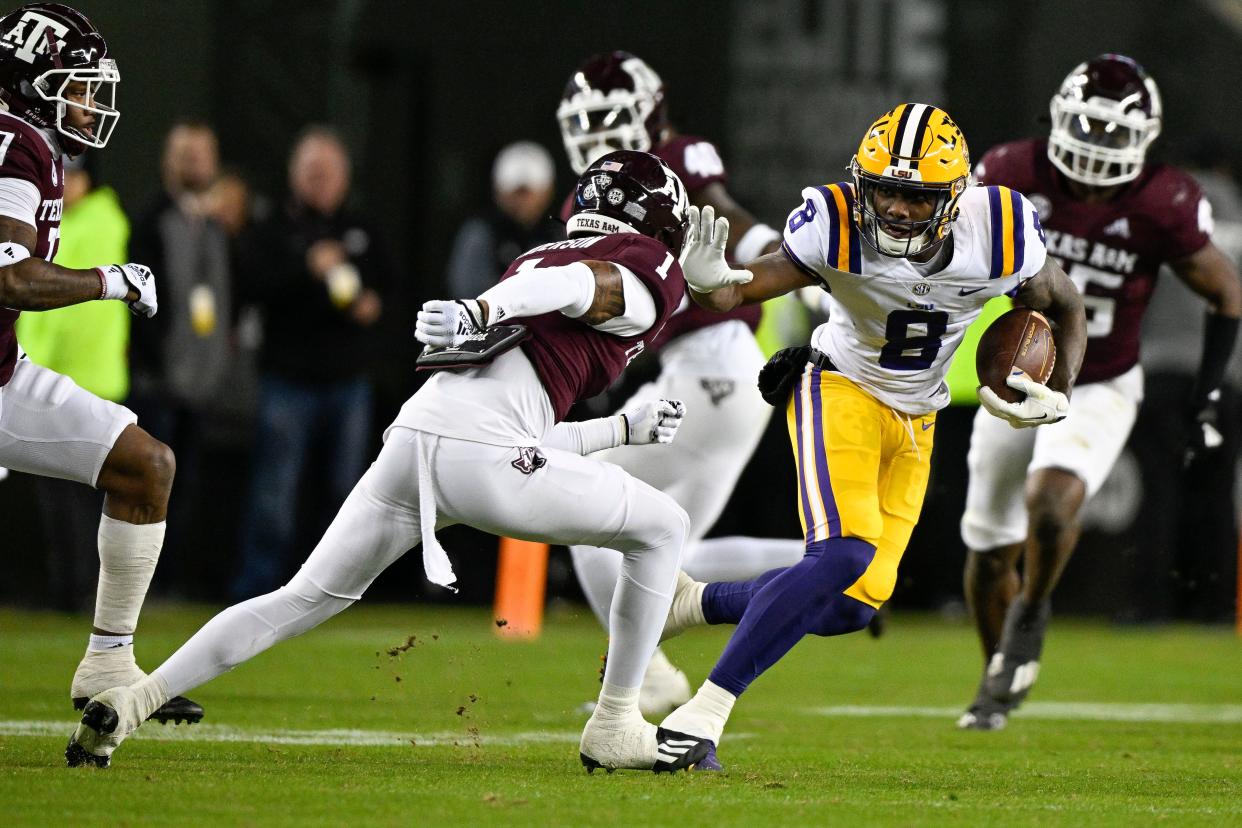 LSU Tigers wide receiver Malik Nabers (8) tries to elude Texas A&M Aggies defensive back Bryce Anderson (1) during the second quarter at Kyle Field.