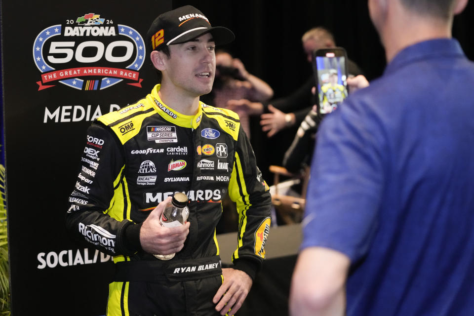 Ryan Blaney talks with a reporter during NASCAR Daytona 500 auto racing media day at Daytona International Speedway, Wednesday, Feb. 14, 2024, in Daytona Beach, Fla. (AP Photo/John Raoux)