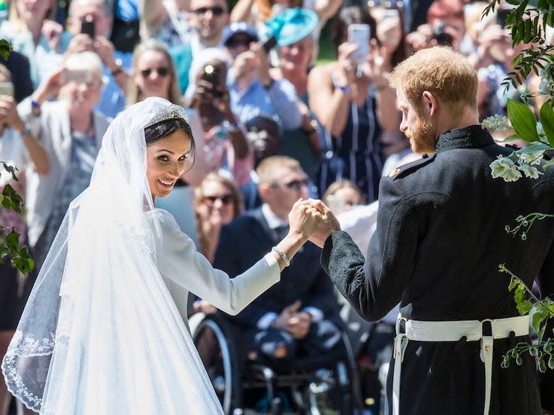 The Duke and Duchess of Sussex on the steps of St George's Chapel at Windsor Castle following their wedding ceremony in St George's Chapel at Windsor Castle on May 19, 2018 in Windsor, England.