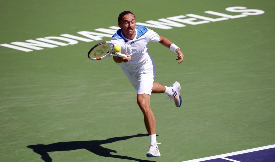 Alexandr Dolgopolov, of Ukraine, returns a shot to Roger Federer, of Switzerland, during their semifinal match at the BNP Paribas Open tennis tournament, Saturday, March 15, 2014, in Indian Wells, Calif. (AP Photo/Mark J. Terrill)