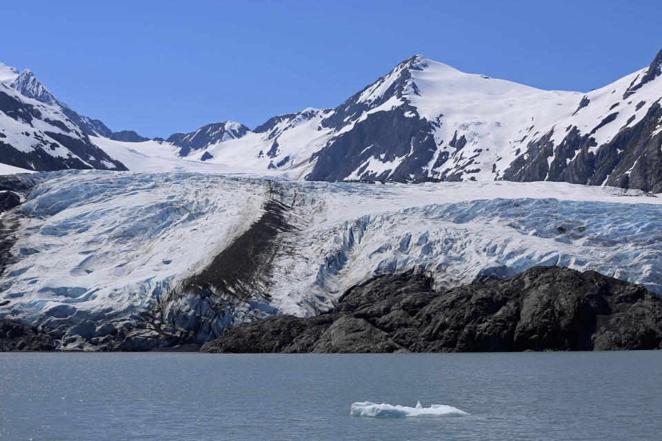 FILE - In this June 14, 2021, file photo, a chunk of ice floats past the Portage Glacier near Girdwood, Alaska. Evan though the glacier is retreating, it's still a half mile wide and four miles long. (AP Photo/Mark Thiessen, File)