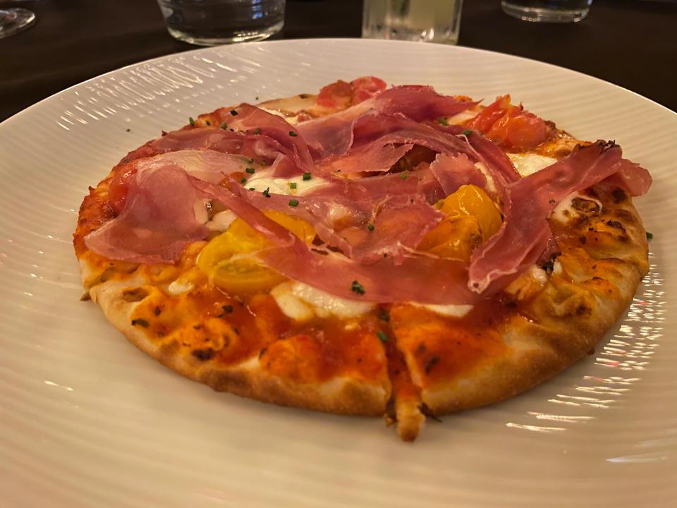 An heirloom tomato flatbread with wisps of speck from The Cave Wine Bar & Bistro in North Naples.