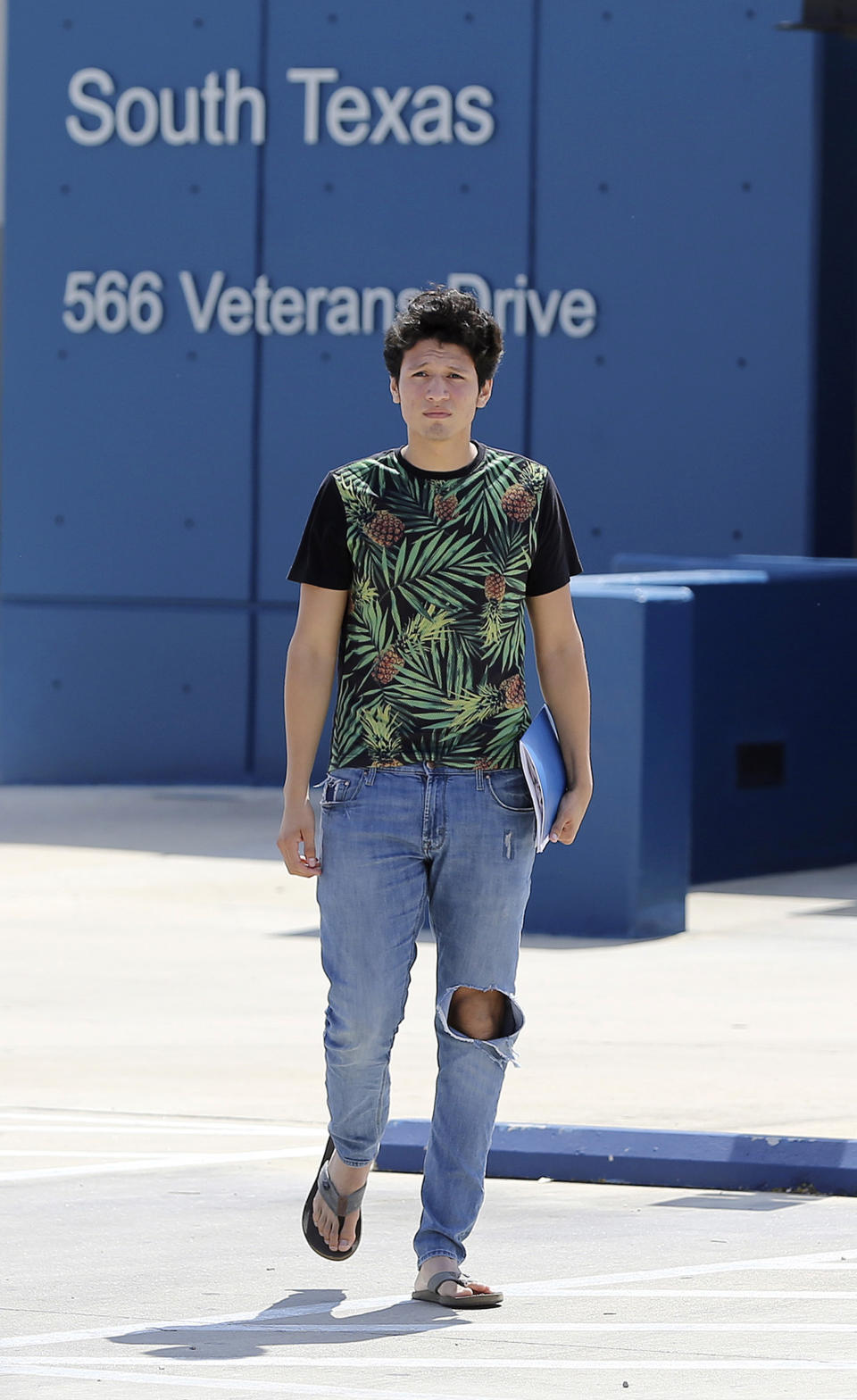 U.S. citizen Francisco Galicia, 18, walks out on his own from the South Texas Detention Facility in Pearsall, Texas, Tuesday, July 23, 2019. Galicia who was born in the U.S. has been released from immigration custody after wrongfully being detained for more than three weeks. Galicia was traveling north with a group of friends when they were stopped at a Border Patrol inland checkpoint, and he was detained for three weeks by the Border Patrol, then transferred to the ICE detention center. (Kin Man Hui/San Antonio Express-News)/The San Antonio Express-News via AP)