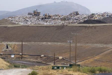 Bulldozers move trash atop of a 300-feet tall hill at the Simi Valley Landfill and Recycling Center in Simi Valley, California May 8, 2008. REUTERS / Hector Mata