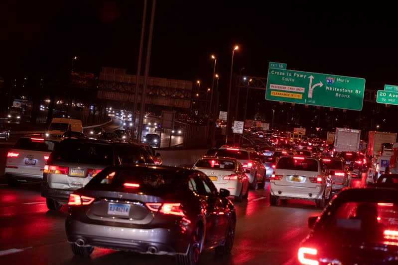 Lights illuminate the roadway as cars sit in traffic to depart New York City the day before the Thanksgiving holiday in New York