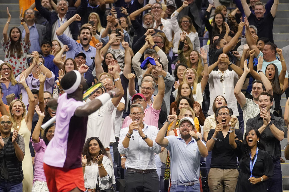 The crowd reacts as Frances Tiafoe, of the United States, wins the fourth set against Carlos Alcaraz, of Spain, during the semifinals of the U.S. Open tennis championships, Friday, Sept. 9, 2022, in New York. (AP Photo/Charles Krupa)