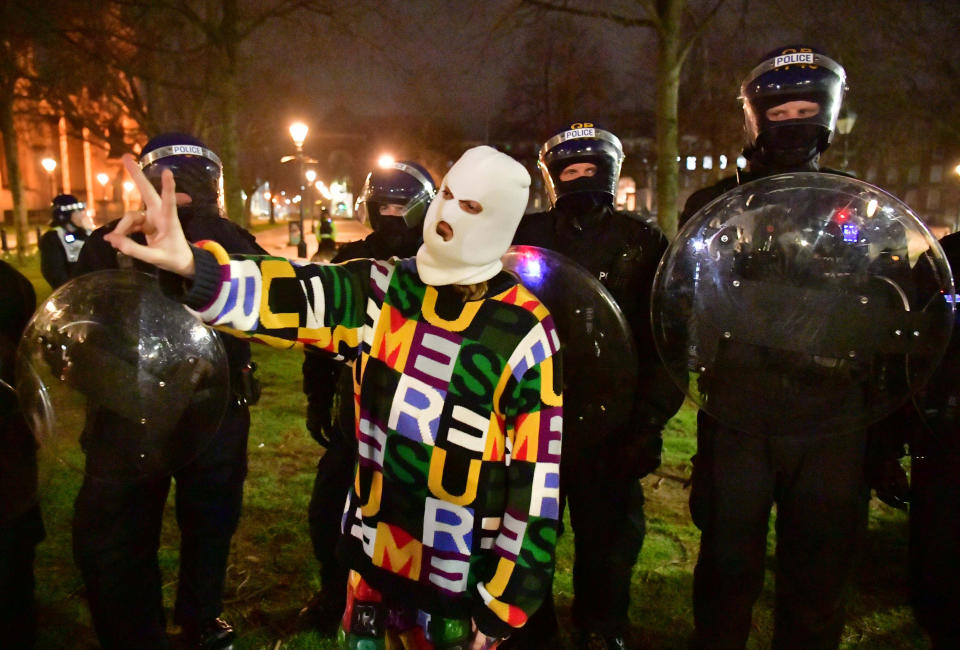 Police and protesters at College Green in Bristol where police said around 130 people had gathered earlier in the evening. Picture date: Tuesday March 23, 2021.