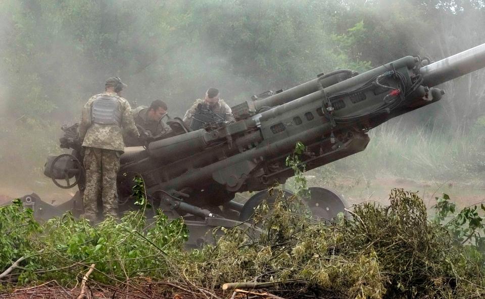 Ukrainian soldiers prepare to fire at Russian positions from a U.S.-supplied M777 howitzer in Ukraine's eastern Donetsk region Saturday, June 18, 2022.