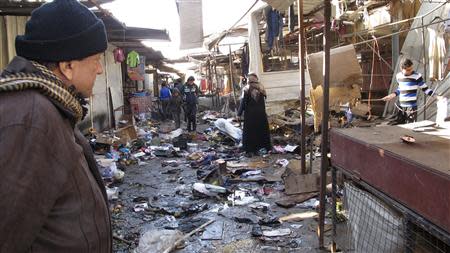 A man looks at the site of bomb attack at a marketplace in Baghdad's Doura District December 25 2013. REUTERS/Ahmed Malik