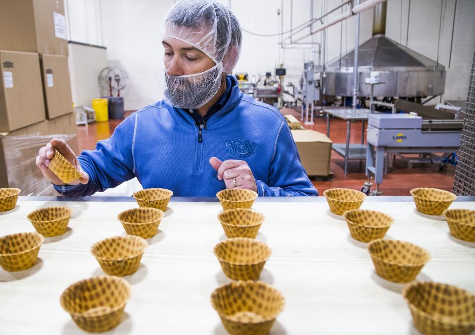 Joy Cone Company general manager Joe Pozar, Jr.,checks out waffle cups as they move down the conveyor belt at the Joy Cone Company plant in Flagstaff, Wednesday, November 29, 2018.