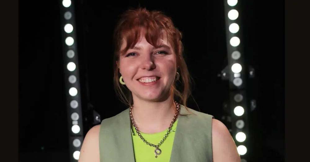 Photo of Irish comedian Marty Gleeson wearing a green vest and smiling.