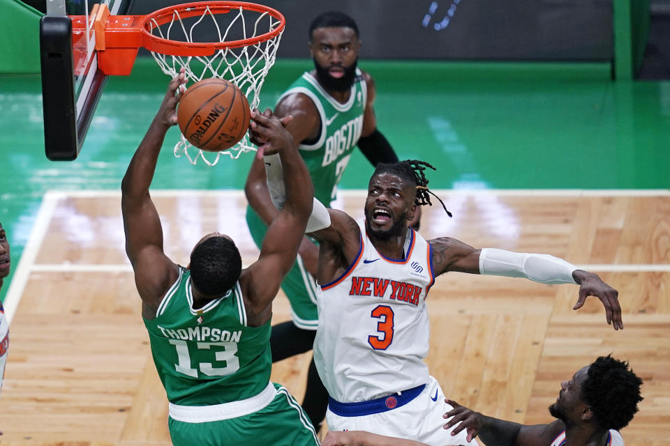 New York Knicks center Nerlens Noel (3) blocks a shot by Boston Celtics center Tristan Thompson (13) during the first half of an NBA basketball game Wednesday, April 7, 2021, in Boston. (AP Photo/Charles Krupa)