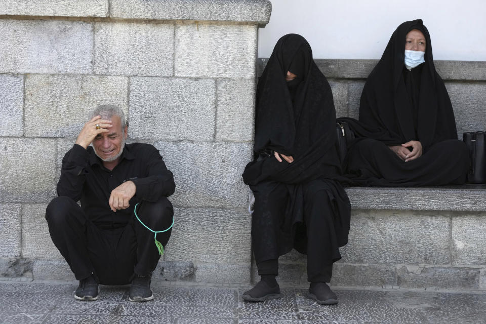 People mourn during an annual procession commemorating Ashoura which marks the death anniversary of Imam Hussein, the grandson of Prophet Muhammad, who was killed with 72 of his companions in the 7th century in the Battle of Karbala in present-day Iraq, in Tehran, Iran, Monday, Aug. 8, 2022. (AP Photo/Vahid Salemi)