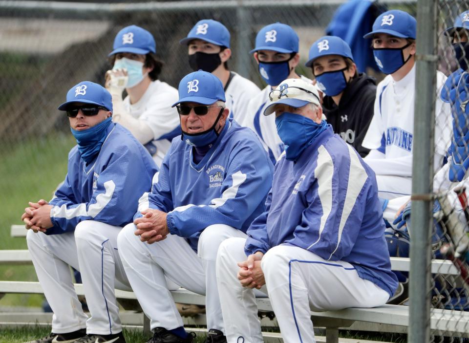 Brandywine head coach Larry Wheeler (front row, center) watches his team against A.I. du Pont en route to his 500th win Saturday, April 17, 2021 at home.