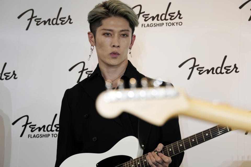 Japanese guitarist Miyavi holding his Fender guitar attends the opening ceremony of its Tokyo store, Thursday, June 29, 2023. Fender, the guitar of choice for some of the world’s biggest stars from Jimi Hendrix to Eric Clapton, is opening what it calls its “first flagship store” in its 77-year history. (AP Photo/Eugene Hoshiko)
