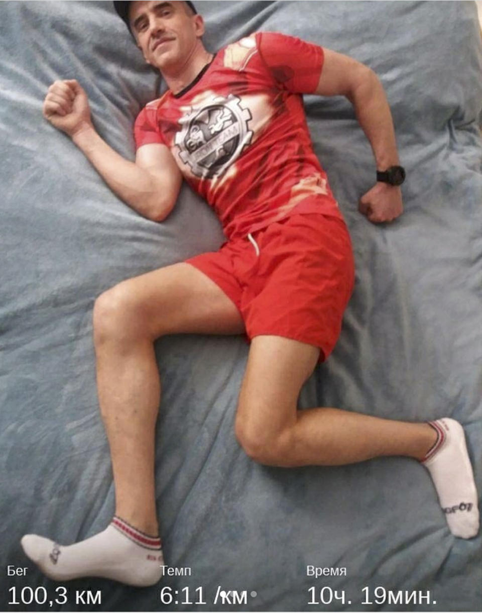 This photo made available by ultramarathon runner Dmitry Yakukhny shows him posing for a selfie at his home in Vladivostok, Russia, Wednesday, April 22, 2020. A Russian man has competed a 10-hour run around his bed during a coronavirus lockdown. Experienced ultra-runner Dmitry Yakukhny was meant to be spending April at the 250-kilometer (155-mile) Marathon des Sables in the Sahara Desert, but was stuck at home after it was postponed to September. (yakuhnyi_dmitry via AP)