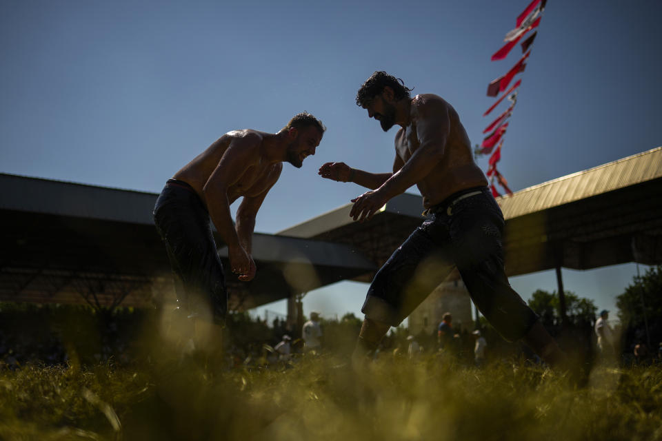 Wrestlers compete during the 661st annual Historic Kirkpinar Oil Wrestling championship, in Edirne, northwestern Turkey, Saturday, July 2, 2022. The festival is part of UNESCO's List of Intangible Cultural Heritages. (AP Photo/Francisco Seco)