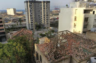 Damaged heritage houses overlooking the site of the Aug. 4 explosion that hit the seaport of Beirut, Lebanon, Thursday Aug. 27, 2020. In the streets of Beirut historic neighborhoods, workers are erecting scaffolding to support buildings that have stood for more than a century - now at risk of collapse after the massive Aug. 4 explosion that tore through the capital. The explosion damaged thousands of buildings, including dozens of Ottoman and French mandate-era structures that had been among the few survivors of a years-old construction frenzy replacing traditional houses with modern buildings. (AP Photo/Hussein Malla)