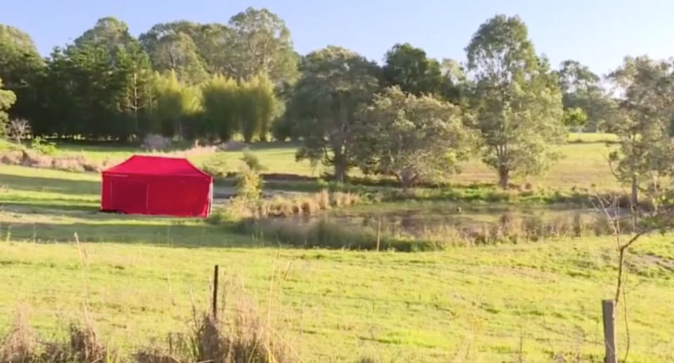 A red tent sits on a rural property at Cootharaba near a dam. It's where Elenore Lindsay, 3, was found dead.