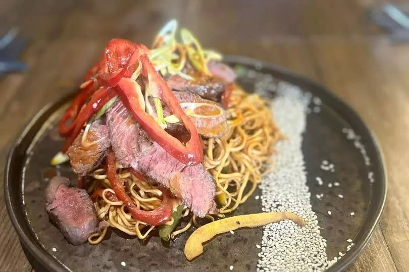 Spicy beef noodles on a wooden table at the Roberttown in Ynysybwl, Pontypridd