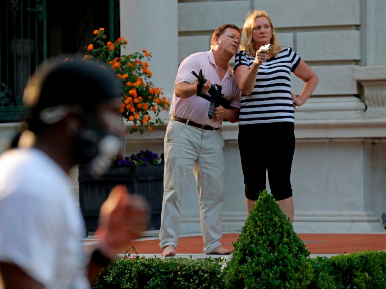 Mark and Patricia McCloskey pointing guns at Black Lives Matters protesters in St Louis in June: AP