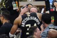 Milwaukee Bucks forward Giannis Antetokounmpo (34) hugs Milwaukee Bucks head coach Mike Budenholzer after defeating the Phoenix Suns in Game 6 of basketball's NBA Finals in Milwaukee, Tuesday, July 20, 2021. The Bucks won 105-98. (AP Photo/Paul Sancya)