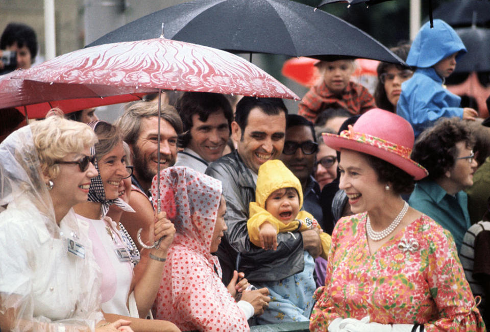 Queen Elizabeth II greets onlookers in light rain outside the National Arts Centre in Ottawa, Canada, on Aug. 1, 1973.<span class="copyright">Bettmann Archive</span>