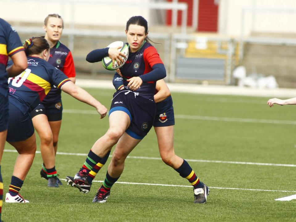 Impartial Reporter: Valley's winger Emma McKenna gets caught by the Banbridge defender.