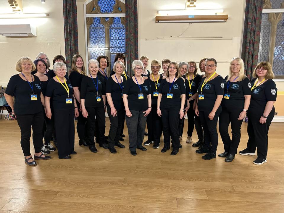 The River City Chorus in Exeter also performed the HelpUkraineSong wearing Ukrainian lanyards (River City Chorus/PA)