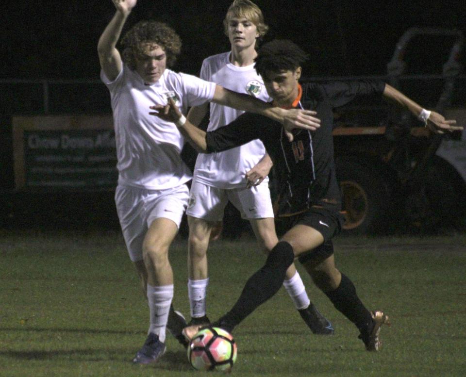 Nease defender Jack LaGrandeur (28) and Mandarin forward Antonio Mancinotti (11) challenge for possession  during a high school boys soccer game on January 4, 2023. [Clayton Freeman/Florida Times-Union]