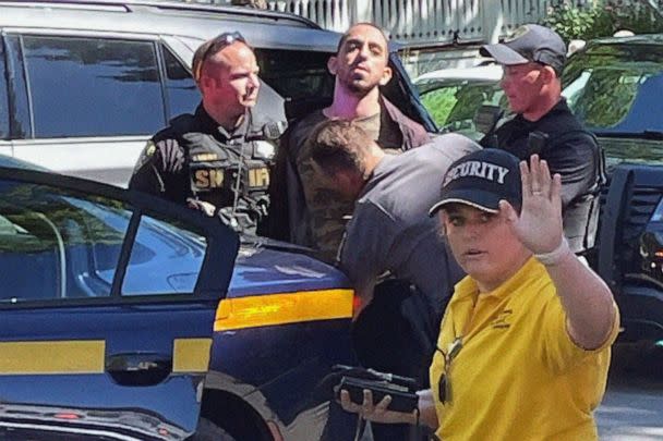 PHOTO: Law enforcement officers detain a person outside the Chautauqua Institution, in Chautauqua, N.Y., Aug. 12, 2022. Author Salman Rushdie was attacked by a man who rushed the stage, as Rushdie was about to give a lecture at the institute. (Charles Fox/AP)