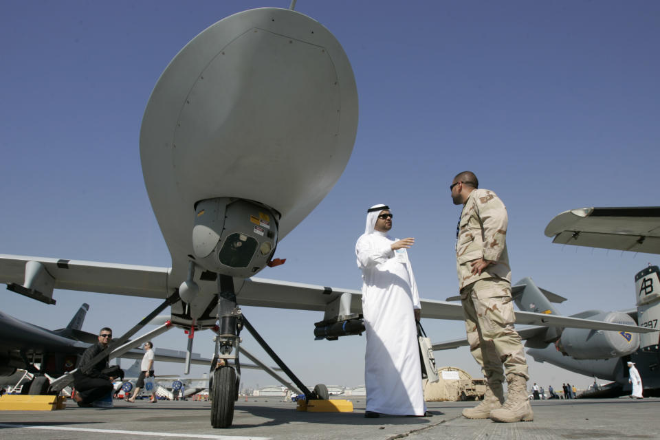 FILE - In this file photo take Monday Nov. 12, 2007, an Emirati visitor asks a question to a military representative as they stand next to an MQ-1 Predator spy plane during the 2nd day of the 10th Dubai Airshow at the Dubai airport, United Arab Emirates. The UAE Prime Minister Sheik Mohammed bin Rashid Al Maktoum said Sunday, Jan. 19, 2014, the Gulf nation has begun the process of imposing mandatory military service for adult males. (AP Photo/Kamran Jebreili, File)