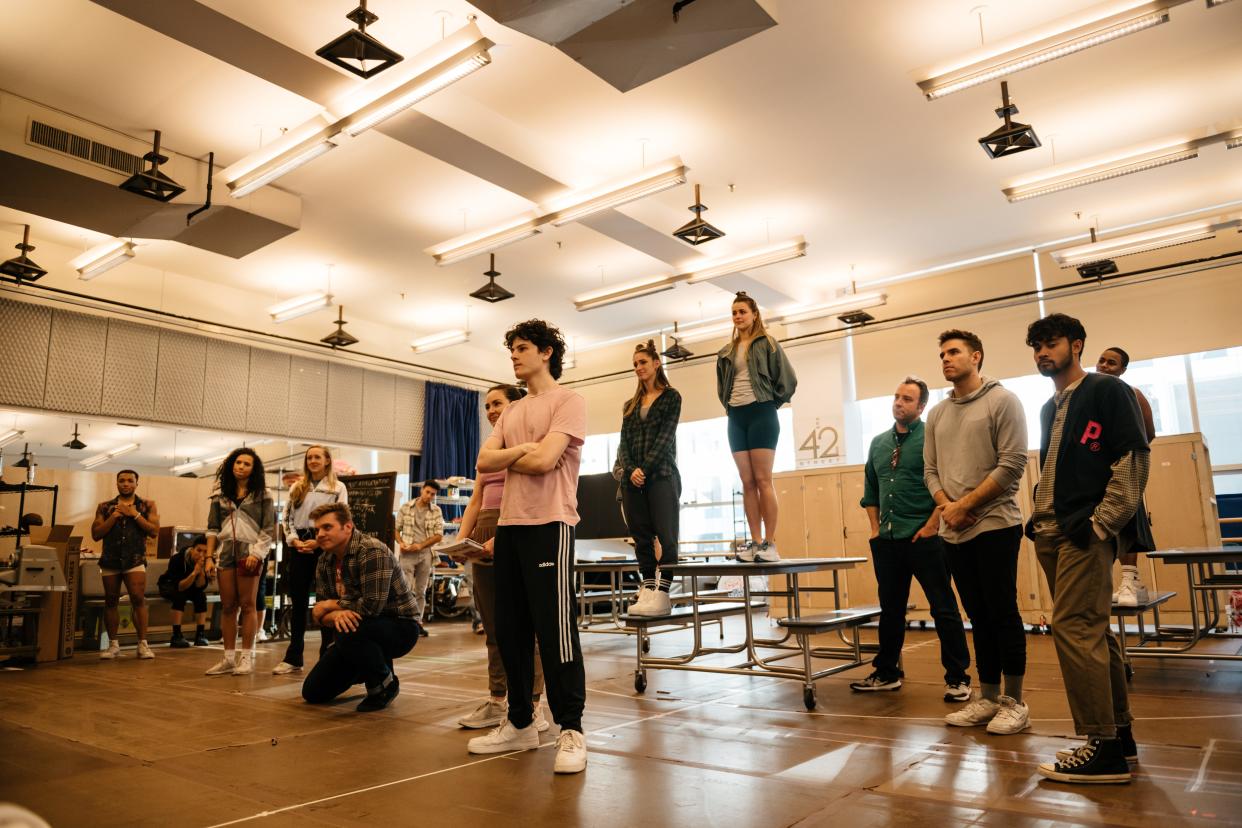 The cast of "Back to the Future: The Musical," including Liana Hunt of Morrisville (center, partially obscured) and Merritt David Janes of Colchester (fourth from right, in green shirt) rehearses at the New 42 Studios in Manhattan.