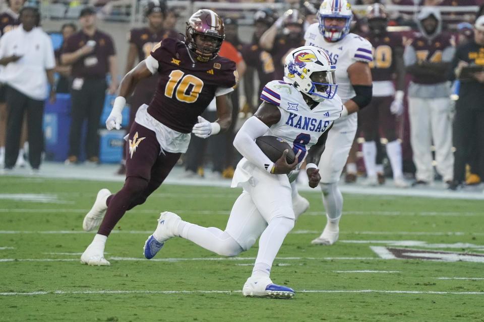 CORRECT PLAYER'S NAME TO JALON DANIELS FROM ISAIAH MARSHALL - Kansas quarterback Jalon Daniels (6) runs away from Arizona State's defensive lineman Clayton Smith (10) and scores a touchdown during the first half of an NCAA college football game Saturday, Oct. 5, 2024, in Tempe, Ariz. (AP Photo/Darryl Webb)