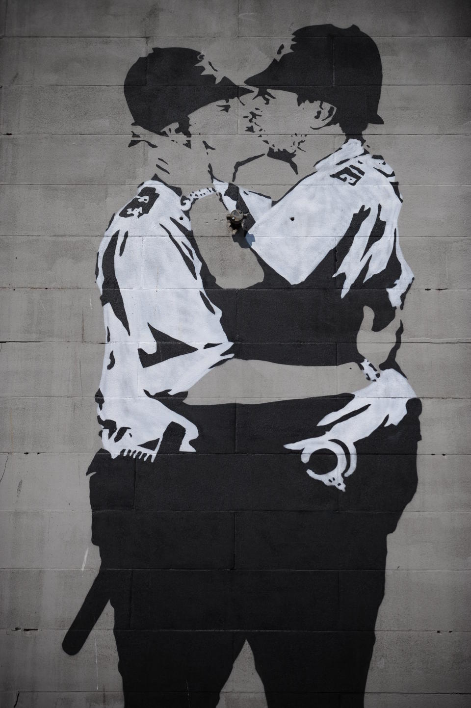 Two policeman kissing are pictured painted on the wall of the old Astoria Theatre in Brighton on July 13, 2014. The artwork replicates an original Banksy mural which was removed from the wall of the Prince Albert pub in Trafalgar Street and sold to an anonymous buyer in Miami for for $575,000 (£345,000). The work reportedly appeared on April Fool's day this year and has been confirmed as a fake by Banksy's representatives. (Photo by: Alex Milan Tracy/Sipa USA)