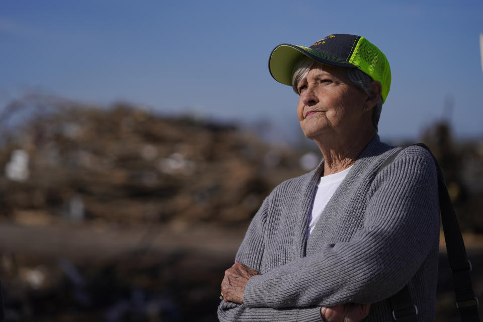 Mary Cockrell looks at the home of her neighbors, Lonnie and Melissa Pierce, who were killed when a semi truck landed on their house during a tornado that hit three days earlier, Monday, March 27, 2023, in Rolling Fork, Miss. Cockrell's home was also damaged during the storm. (AP Photo/Julio Cortez)