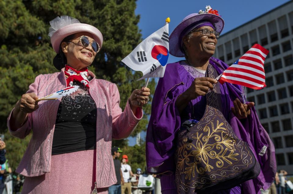 Bokjim Kim, left, and Starla Tartton, 67, dance together in Liberty Park.