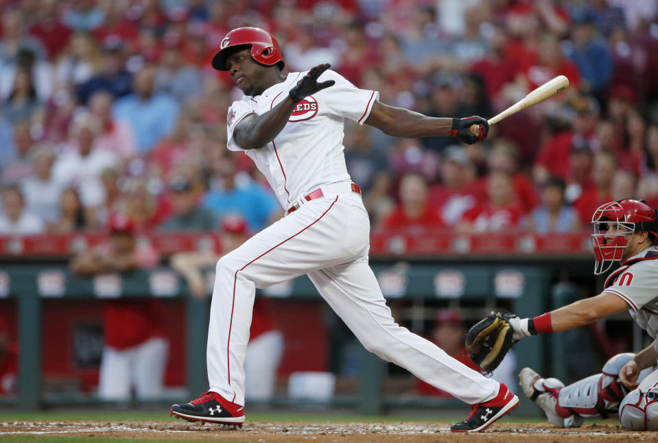 Cincinnati Reds' Aristides Aquino follows through on a two-run double off Philadelphia Phillies starting pitcher Aaron Nola during the second inning of a baseball game, Wednesday, Sept. 4, 2019, in Cincinnati. (AP Photo/Gary Landers)