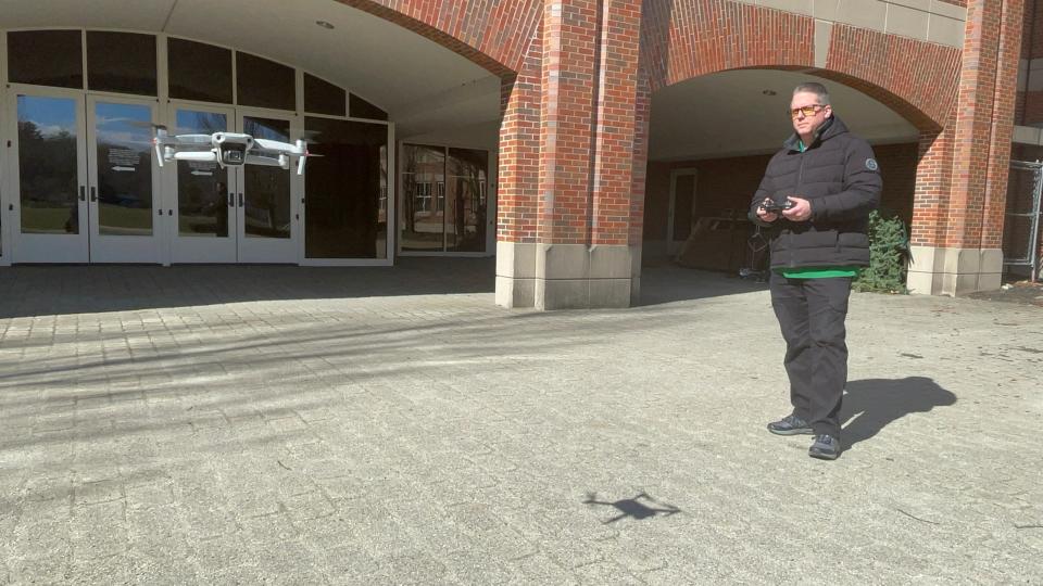 Griswold High School teacher and esports coach Jim Rand flying a drone.