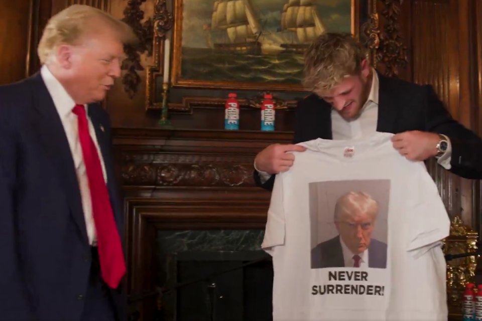 Donald Trump presents Logan Paul with a T-shirt bearing his mugshot ahead of their podcast interview (Impaulsive/X)