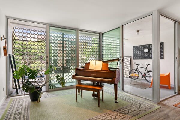 Floor-to-ceiling Fleetwood doors open to a spacious, private balcony.