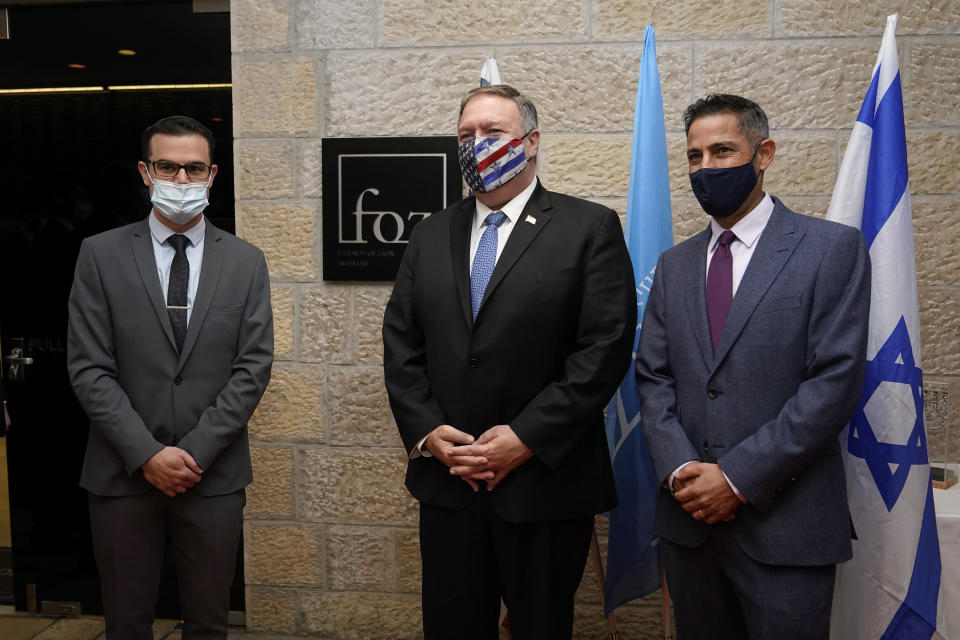 Secretary of State Mike Pompeo, center, poses for a photo with Daniel Voiczek, left, general manager and CEO of the Friends of Zion Museum, and Nir Kimhi, the museum founder's representative in Israel, as he arrives for a tour of the Friends of Zion Museum, Friday, Nov. 20, 2020, in Jerusalem. (AP Photo/Patrick Semansky, Pool)