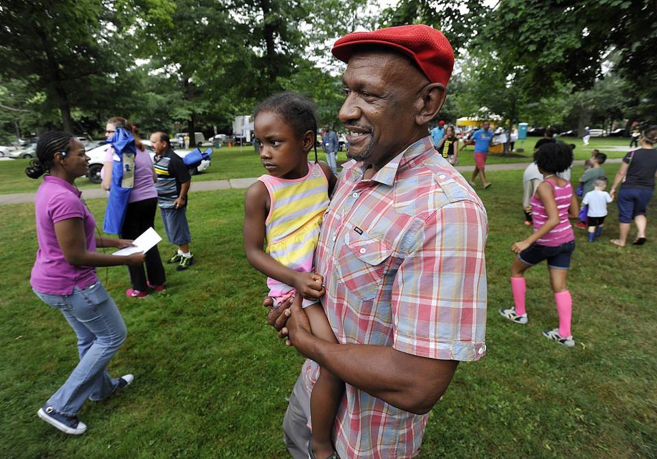 In this file photo, Daryl Craig carries his daughter Dasanaa, then 4, through Gridley Park in Erie during a National Night Out celebration on Aug. 5, 2014.