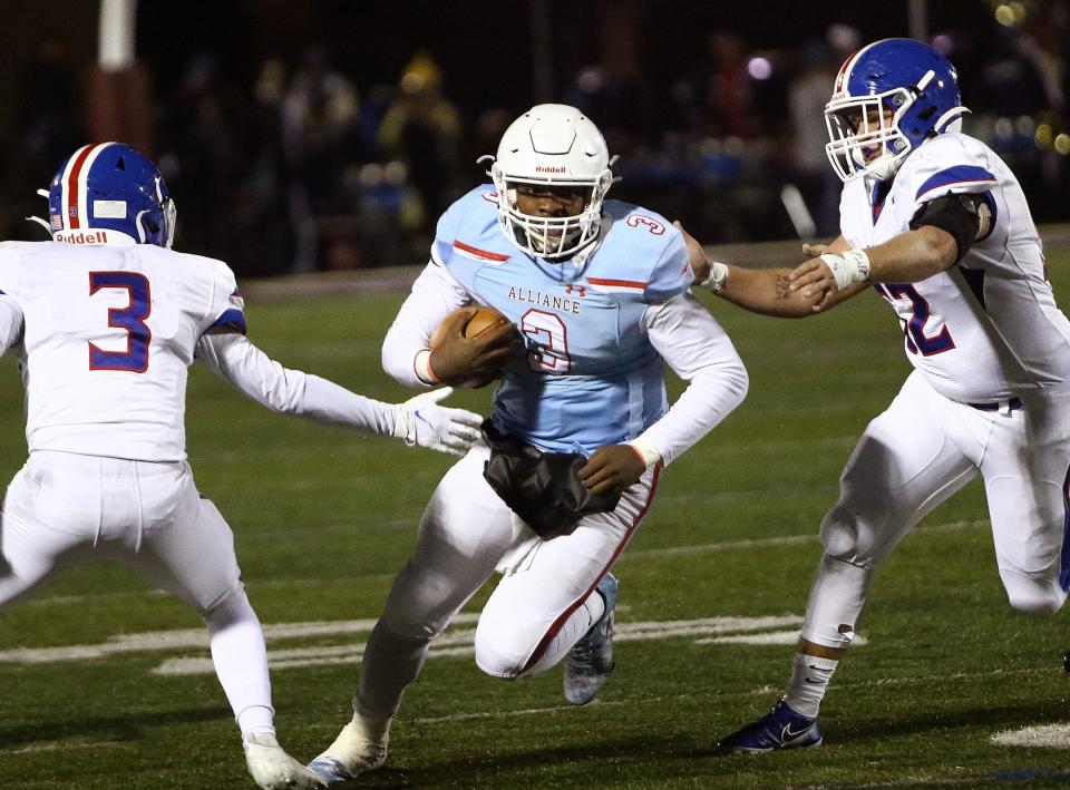 Alliance quarterback Brandon Alexander (3) defended by Lake's Andrew Hammer, left, and Kyle Myers, right, during their game played at Mount Union Stadium Friday, October 30, 2020.