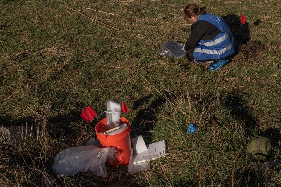 An ecological investigator collects soil in the area that was flooded following the Kakhovka dam explosion, for a war crime investigation into allegations of Russian ecocide (AFP via Getty Images)