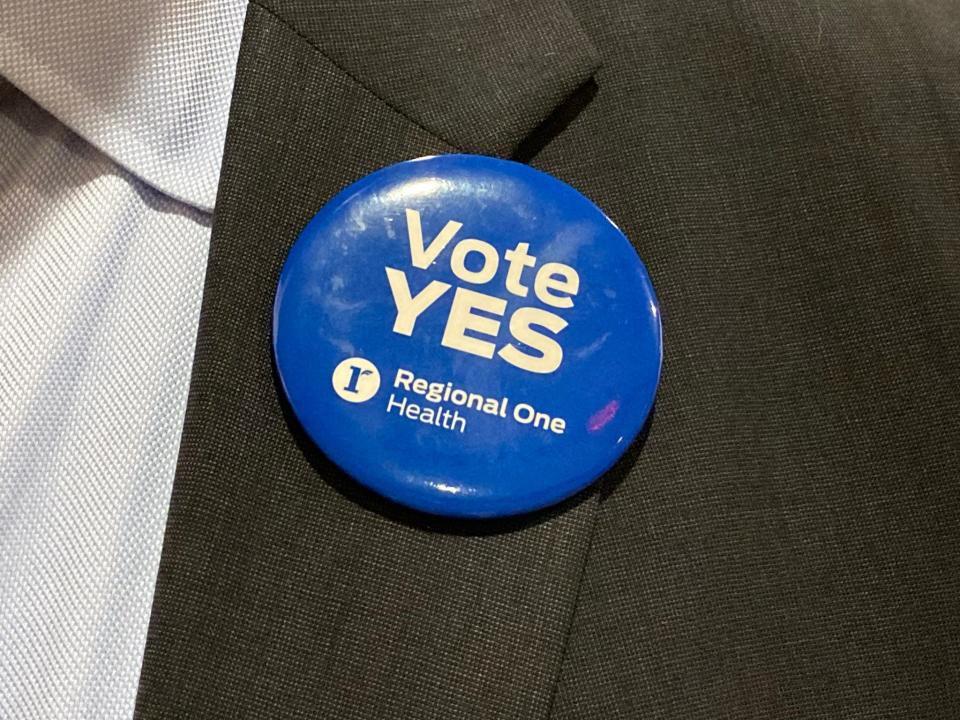 Advocates for Regional One Health wore buttons saying "Vote Yes" and "One Campus" at the Shelby County Commission Monday, June 5, 2023.