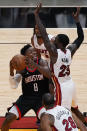 Houston Rockets forward Jae'Sean Tate (8) aims for the basket as Miami Heat guard Kendrick Nunn (25) defends, during the first half of an NBA basketball game, Monday, April 19, 2021, in Miami. (AP Photo/Marta Lavandier)