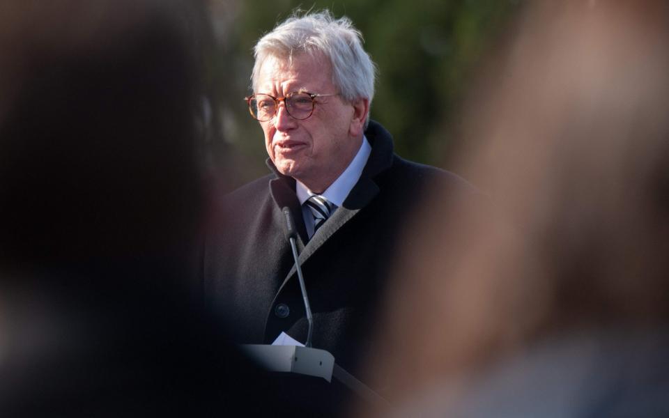 Hesse's State Premier Volker Bouffier speaks during a ceremony to commemorate the victims of the Hanau racist attack, on February 19, 2022 at the cemetery in Hanau, western Germany. - The Hanau shootings occurred two years ago, on February 19, 2020, when a German gunman killed nine people by opening fire in two bars in the city of Hanau near Frankfurt am Main. The 43-year-old man was later found dead alongside the corpse of his mother in his home, leaving behind a 24-page xenophobic "manifesto". (Photo by Boris Roessler / POOL / AFP) (Photo by BORIS ROESSLER/POOL/AFP via Getty Images) - BORIS ROESSLER /AFP